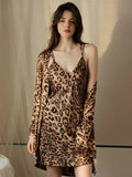 Woman wearing a leopard print satin slip dress and matching robe.