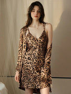 Woman wearing a leopard print satin slip dress and matching robe.