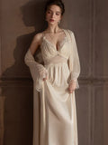 Full body shot of a woman in a cream satin slip dress and robe.