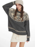 Close-up of a woman modeling a grey Fair Isle crewneck sweater