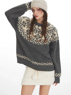 Close-up of a woman modeling a grey Fair Isle crewneck sweater