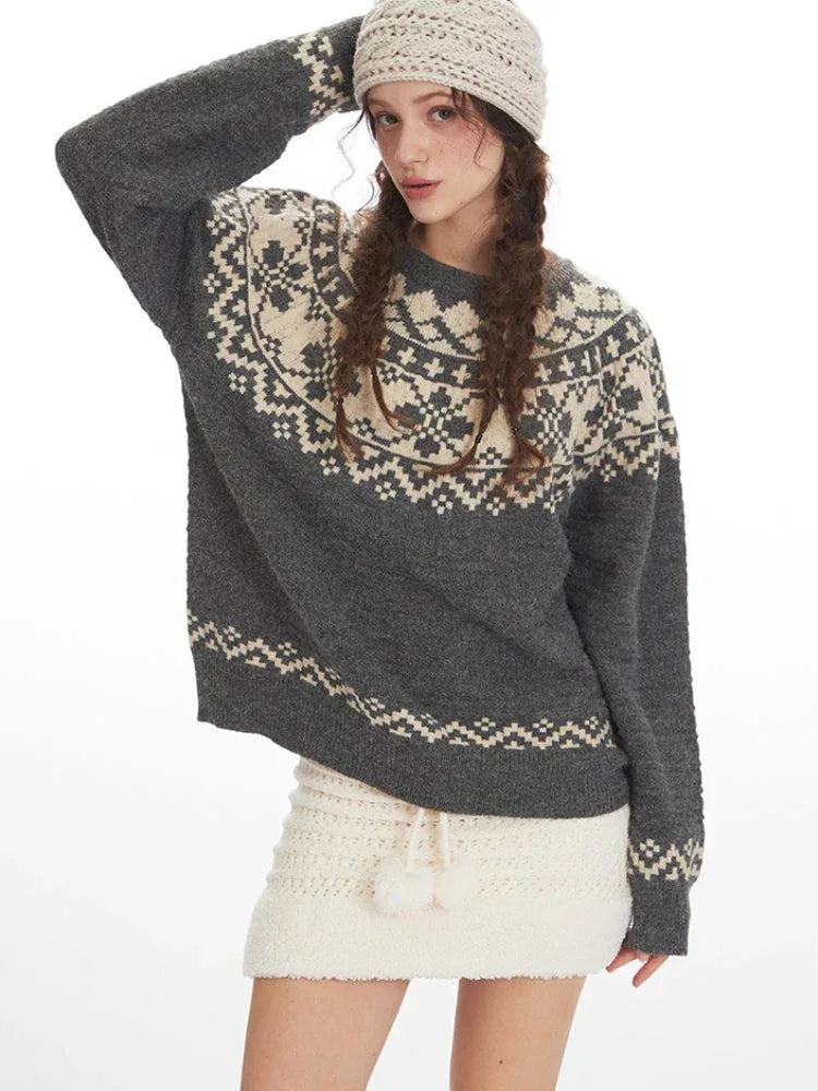 Close-up of a woman modeling a grey Fair Isle crewneck sweater