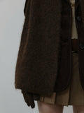 Detail of a brown knit scarf and matching gloves