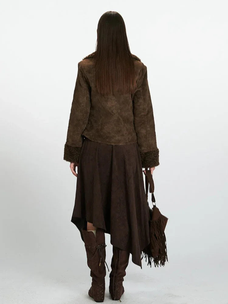 Back view of a woman wearing a brown faux suede jacket with shearling trim.