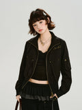 Woman wearing a black bomber jacket with gold hardware