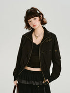 Woman wearing a black bomber jacket with gold hardware