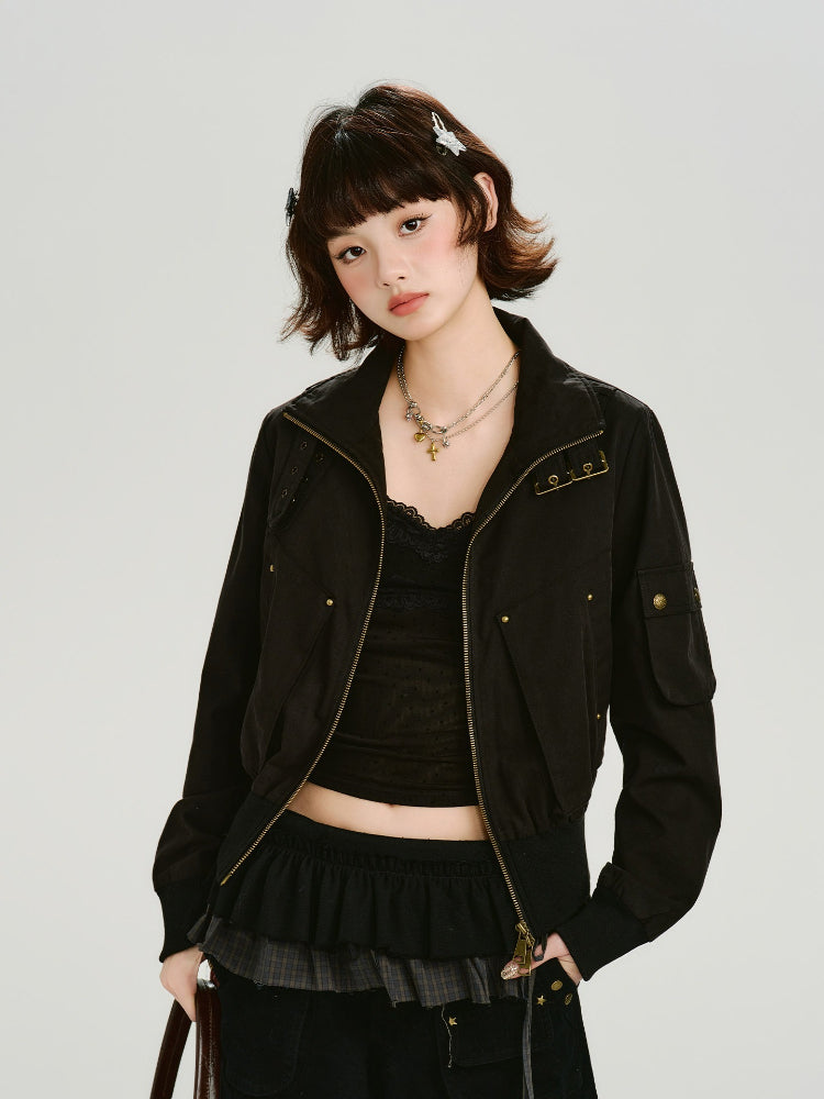 Woman wearing a black bomber jacket with gold hardware