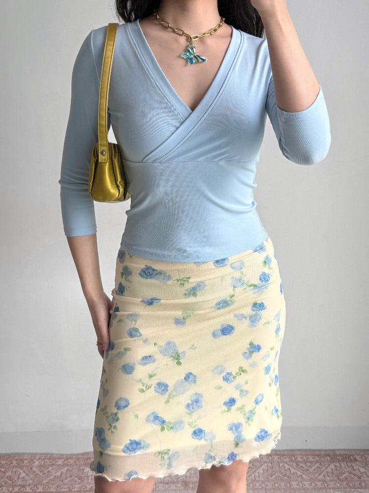 outfit featuring a light blue wrap top and a yellow floral mesh skirt