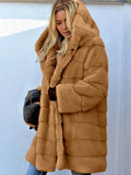 Woman wearing a tan hooded faux fur coat with horizontal paneling.