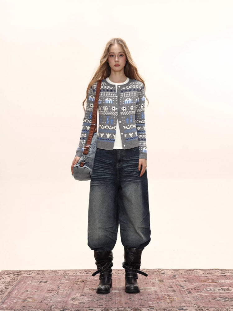 Woman wearing a grey button-down cardigan with a Fair Isle knit pattern, white t-shirt, wide-leg jeans, and a crossbody bag.