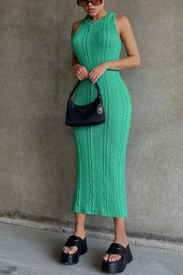 Woman wearing a bright green cable knit midi dress and black platform sandals