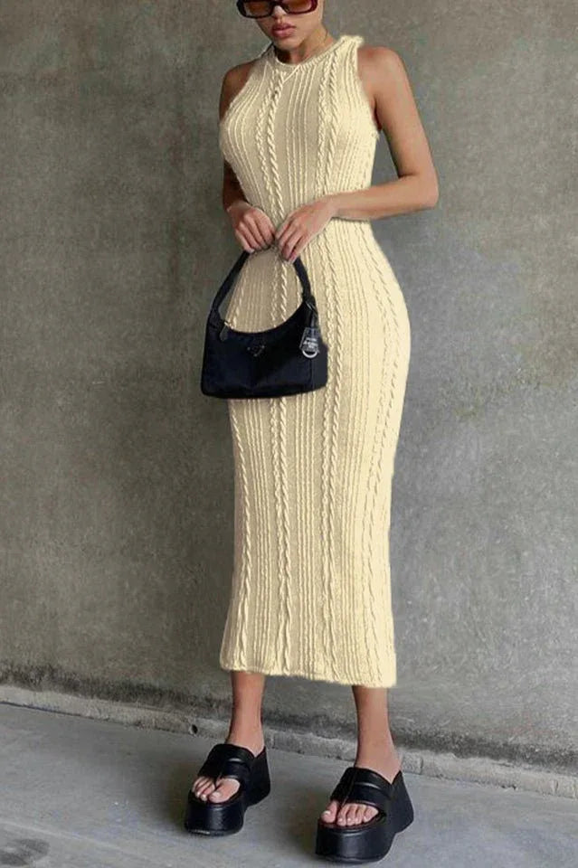 Woman wearing a cream cable knit midi dress and black platform sandals