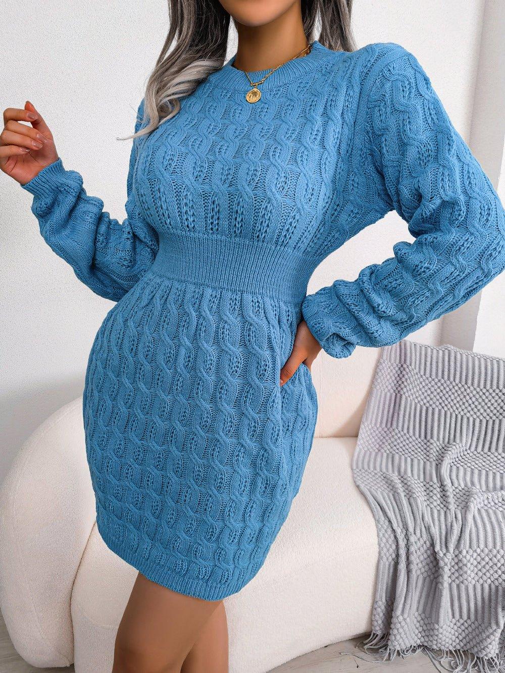 Woman posing in a blue cable knit long sleeve crew neck bodycon dress with a cinched waist.