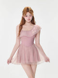 Front view of the pink one-shoulder ruffled dress with sheer skirt