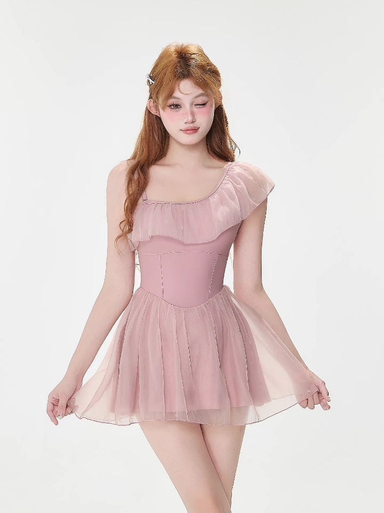 Front view of the pink one-shoulder ruffled dress with sheer skirt