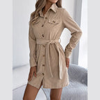 Full view of a woman in a beige corduroy shirt dress.