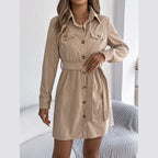 Woman posing in a beige corduroy shirt dress with a self-tie belt.