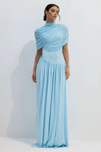 Full length view of a woman in a light blue draped jersey maxi dress.