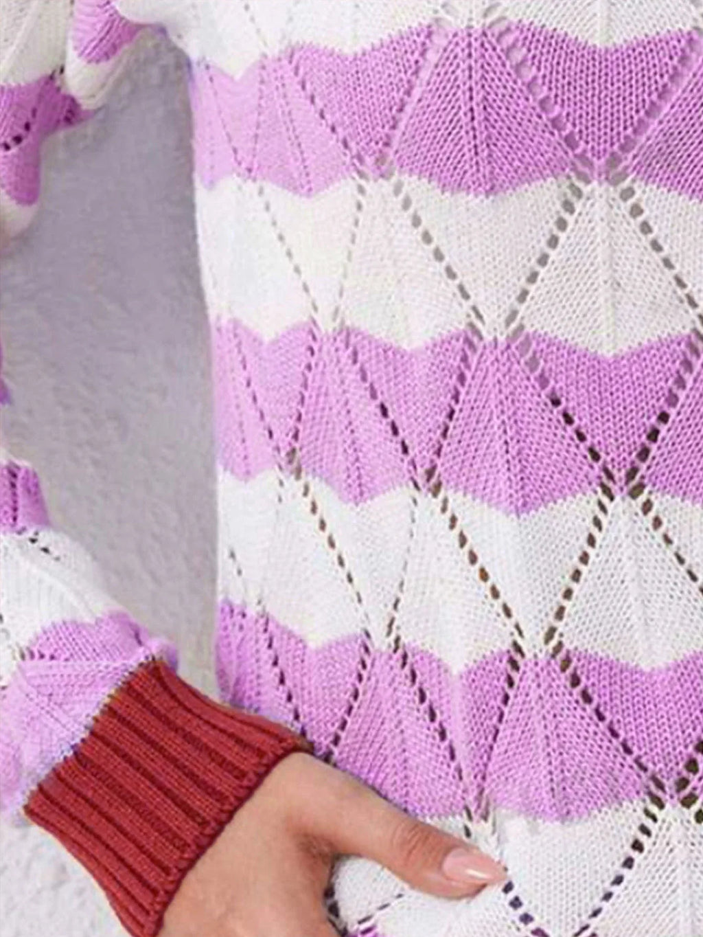 Close-up of the sleeve and cuff detail on a lavender and white knit sweater.