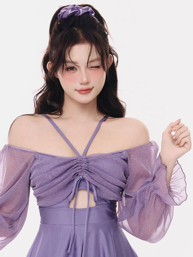 Close-up of the ruched bust and sheer sleeves of the purple swim dress
