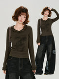 Full body shot of a woman wearing the graphic t-shirt with wide-leg jeans.
