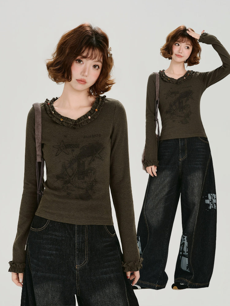 Full body shot of a woman wearing the graphic t-shirt with wide-leg jeans.