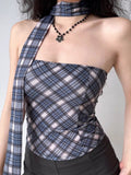 Close-up of a woman wearing a plaid tube top with an asymmetrical scarf detail.