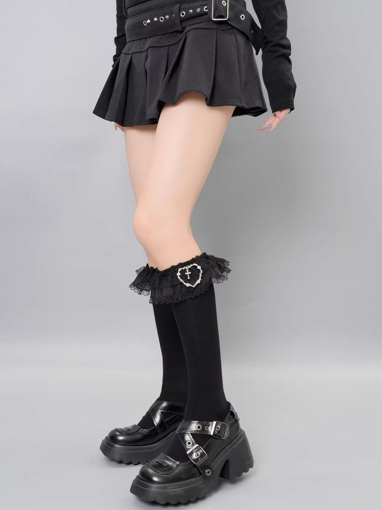 Fashionable black socks with embellished lace tops and charm accent.