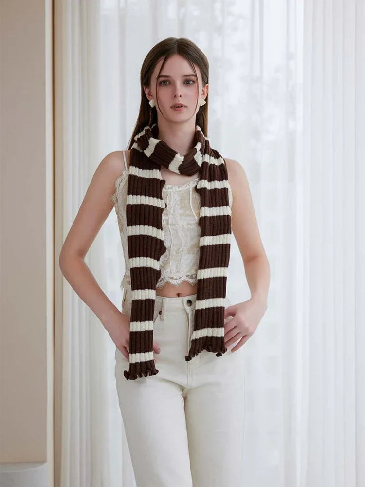 Woman wearing a long black and white striped knit scarf with ruffle edges - View 16 | WEUXS