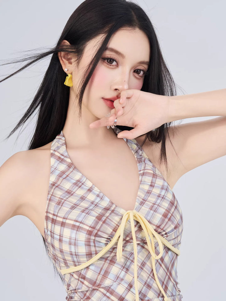 Close-up of the plaid halter dress neckline with yellow tie detail.