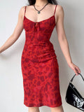 Front view of a woman posing in a red floral print midi dress