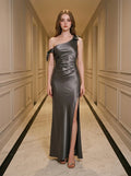 Woman wearing a grey one-shoulder satin gown with a high slit