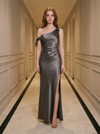 Woman wearing a grey one-shoulder satin gown with a high slit