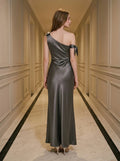 Back view of a woman in a grey one-shoulder satin gown