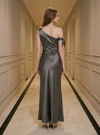 Back view of a woman in a grey one-shoulder satin gown
