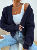 dark blue knit cardigan worn from the back
