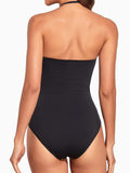 Back view of a woman in a black strapless one-piece swimsuit