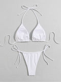 Close-up of the white bikini top featuring triangle cups and halter ties.