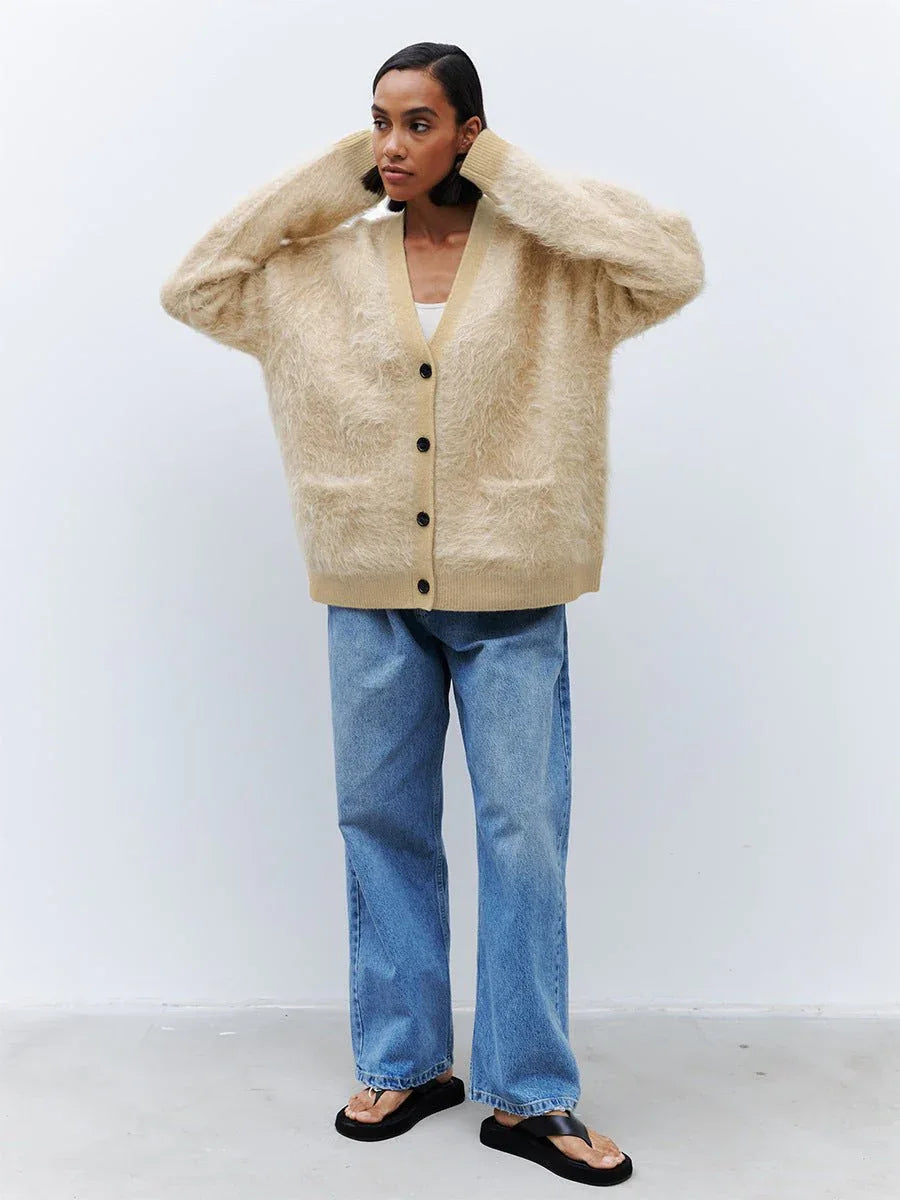 Front view of a woman posing in an oversized faux fur cardigan.