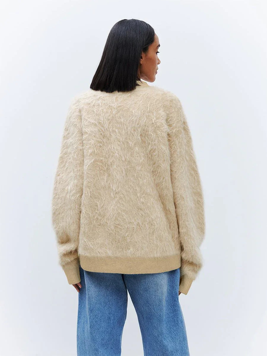 Back view of a woman wearing a relaxed fit faux fur cardigan.