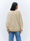 Back view of a woman wearing a relaxed fit faux fur cardigan.