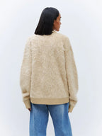 Back view of a woman wearing a relaxed fit faux fur cardigan.