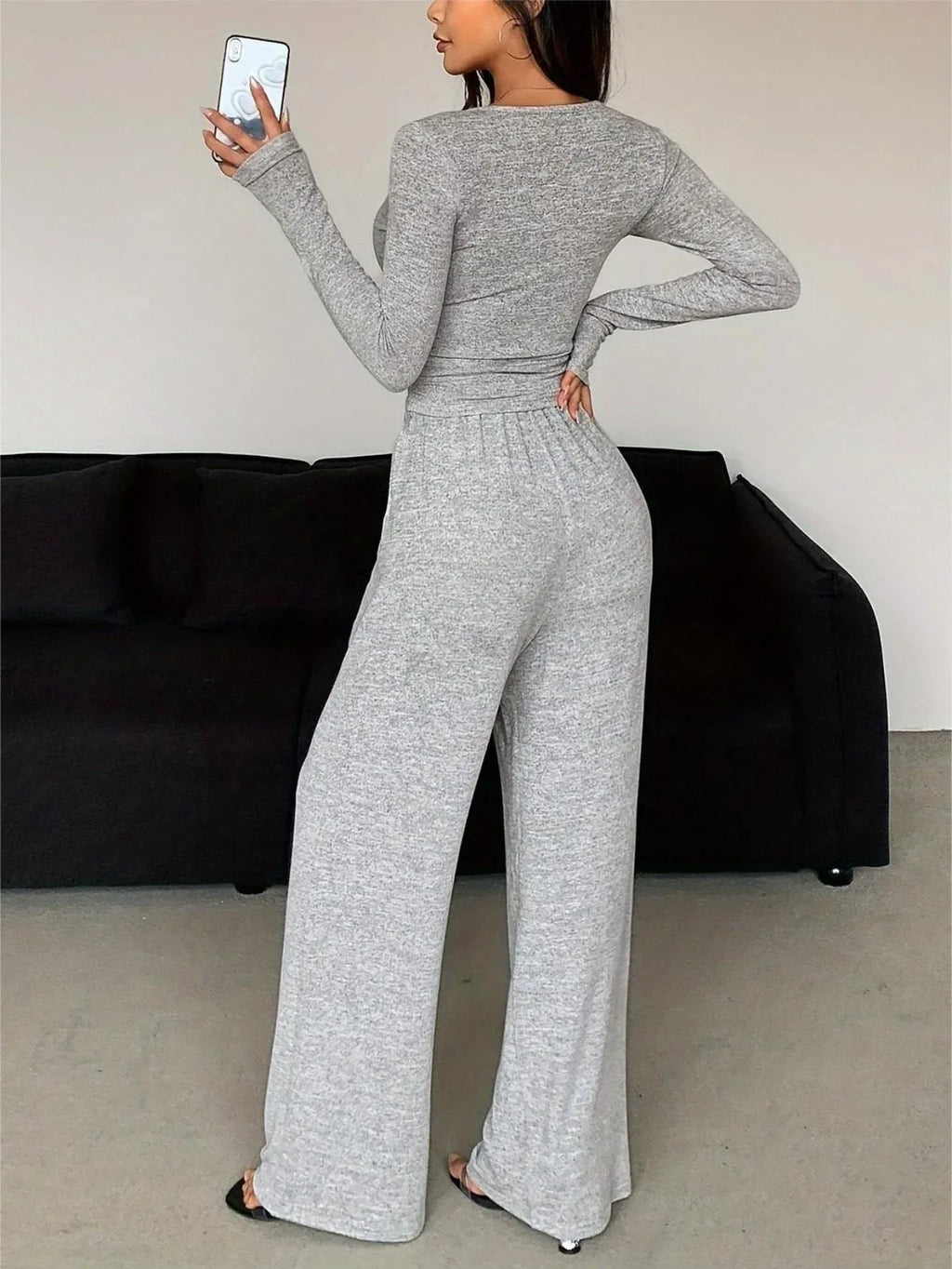Back view of a woman in a grey heathered knit loungewear set.