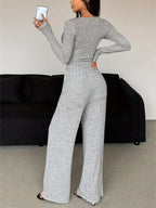 Back view of a woman in a grey heathered knit loungewear set.