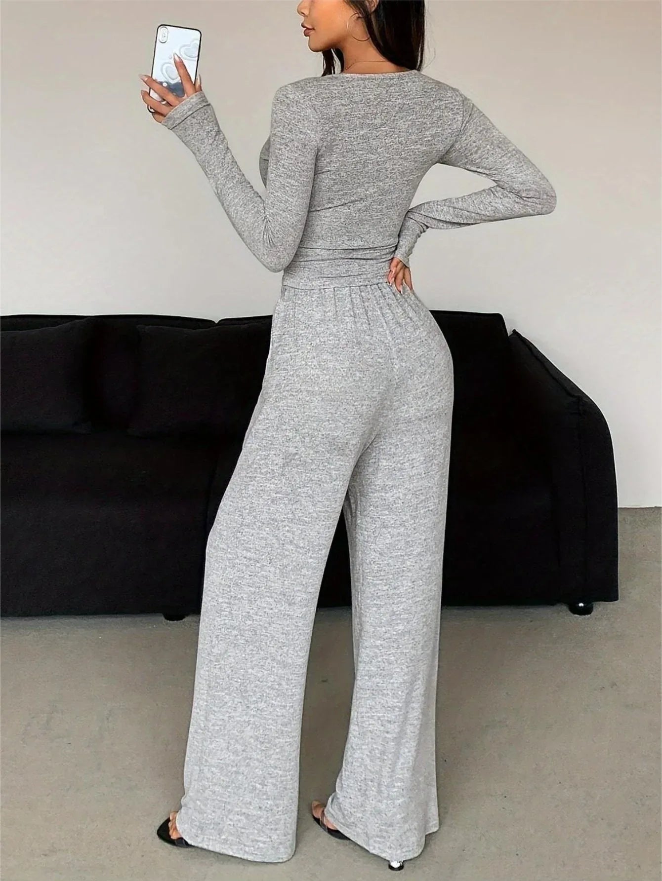 Back view of a woman in a grey heathered knit loungewear set.