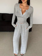 Close-up of the front of a grey heathered knit loungewear set on a woman.