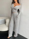 Full body shot of a woman in a grey heathered knit loungewear set.