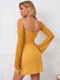 Back view of a yellow bodycon dress with cutout details and long sheer sleeves.
