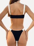Front view of a black and white bikini with a square neckline and ruched details