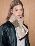 Model showcasing a stylish knit scarf with a colorblock pattern